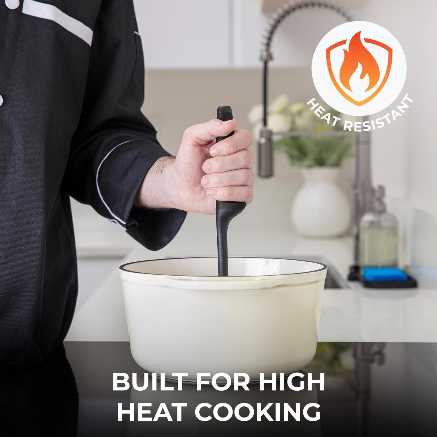 Person using a heat-resistant meat chopper over a pot with a kitchen background, emphasizing high heat cooking.