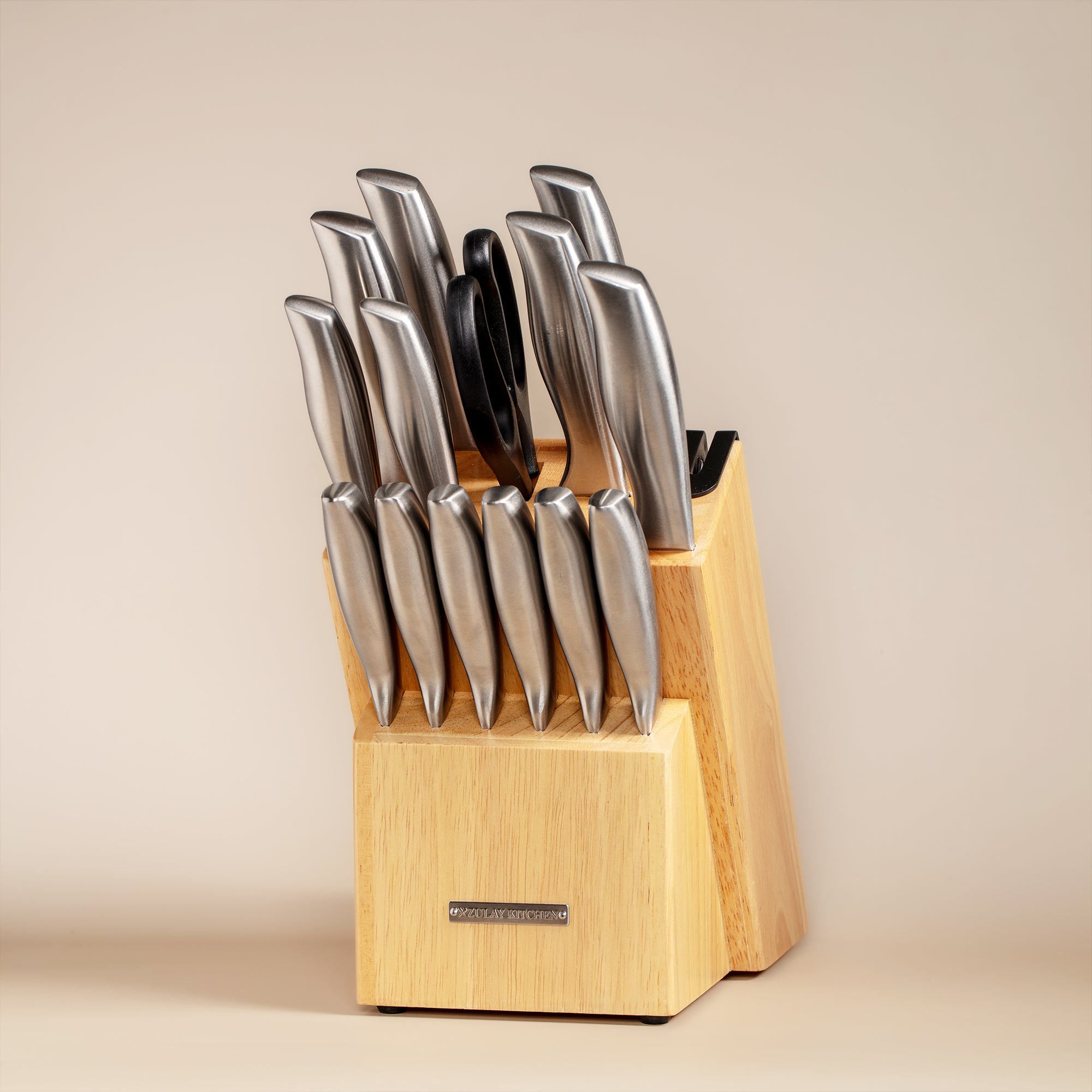 Set of knives in a wooden block on a beige background