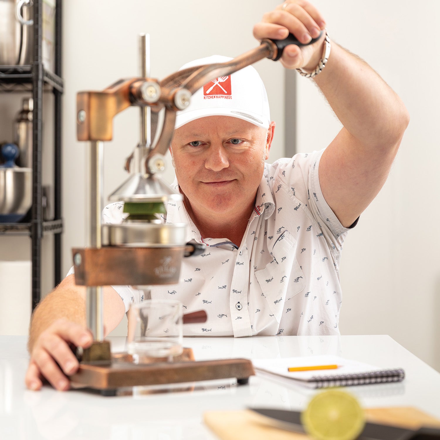 A man testing the Zulay Kitchen manual citrus press.
