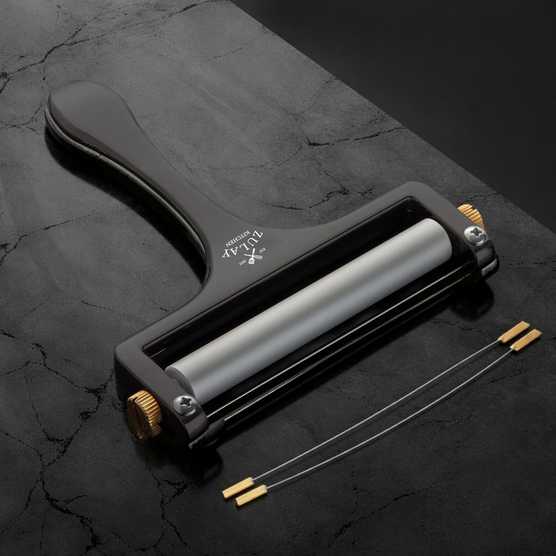 The Zulay Kitchen Wire Cheese Slicer on a dark textured surface