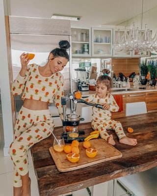 Oxana and Her Little One Enjoying the Benefits of Orange Juice Using a Zulay Kitchen Citrus Juicer - Zulay Kitchen