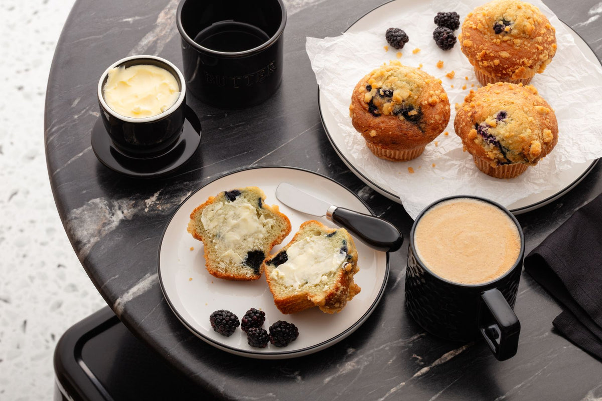 Muffins, Zulay Kitchen ceramic butter crock set, and coffee on a marble table