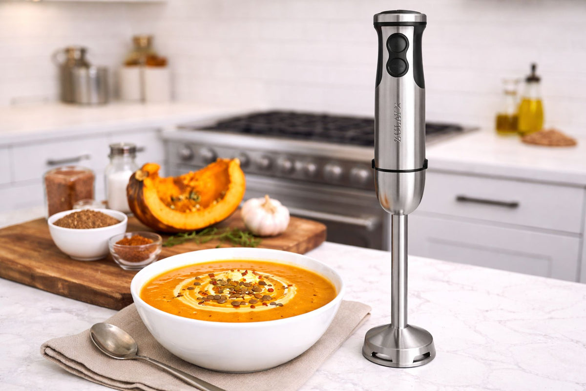 Zulay Kitchen 3-in-1 Immersion Blender next to a bowl of soup on a kitchen counter.