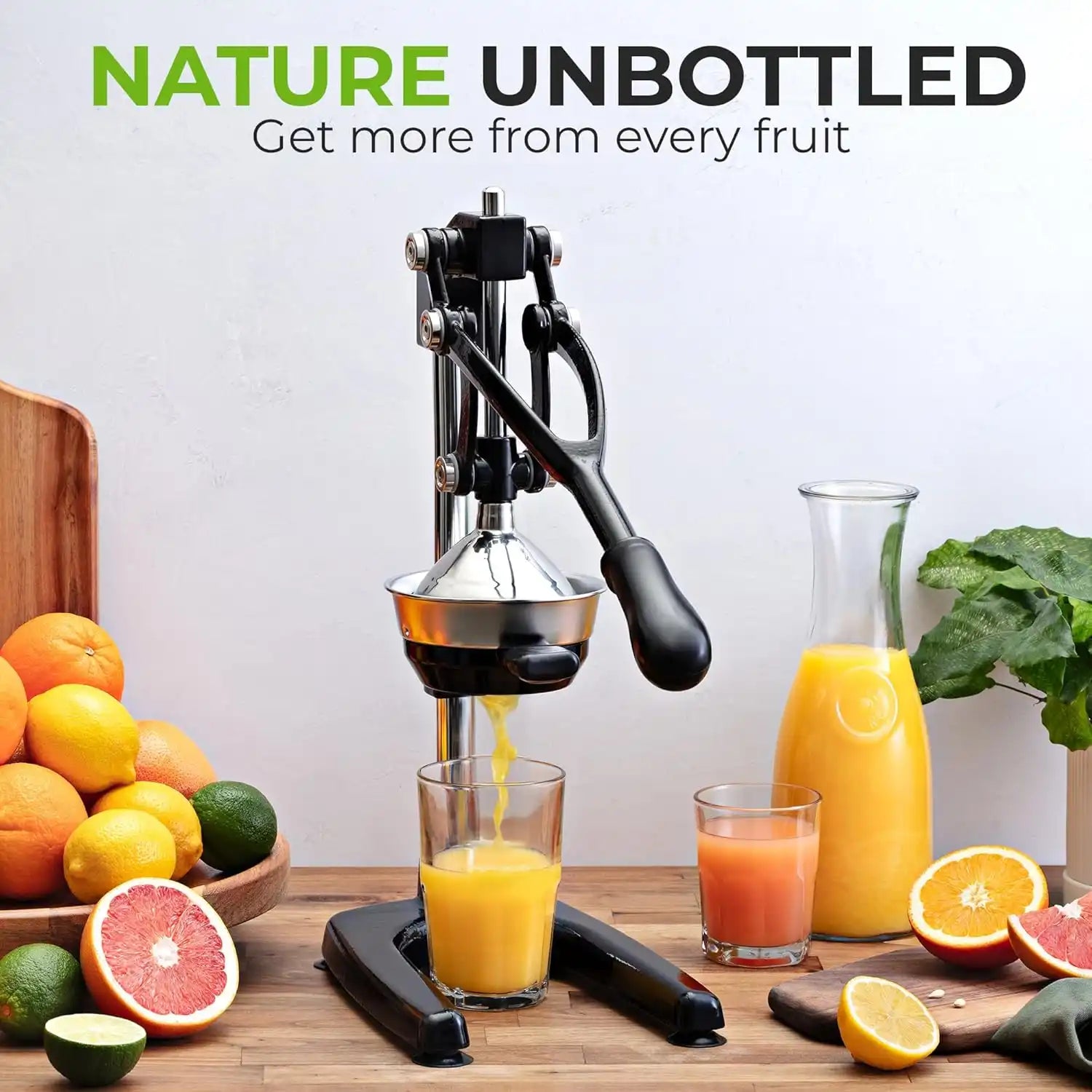 Manual juicer with fresh fruits and juice on a wooden table, promoting 'Nature Unbottled' brand.