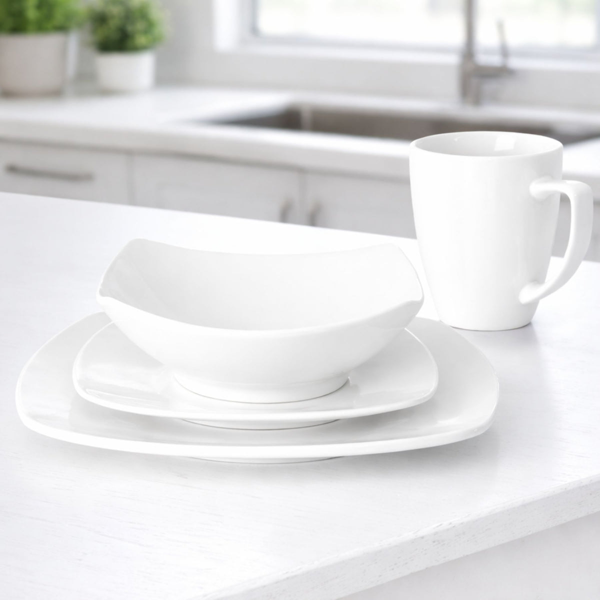 White ceramic dinnerware set on a kitchen counter