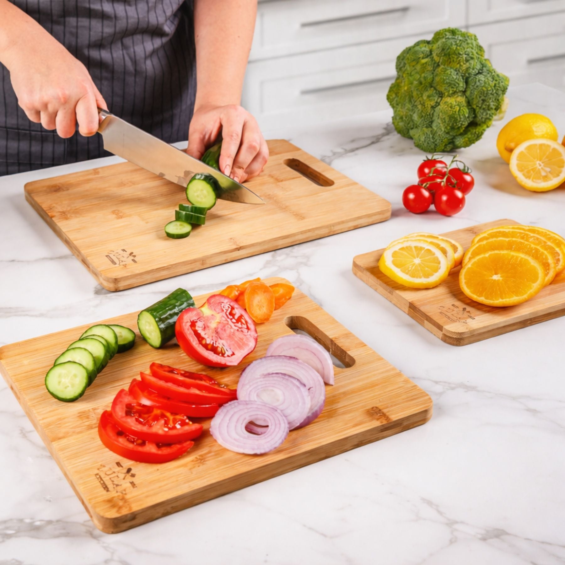 Person slicing vegetables on a wooden cutting board with various fruits and vegetables around.