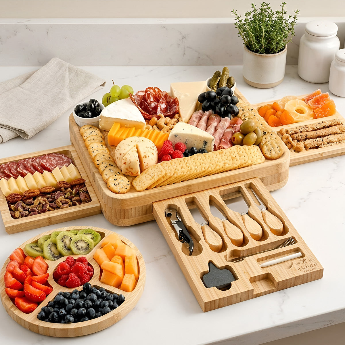 Zulay Kitchen Bamboo Cheese Board Set with assorted foods on a marble countertop