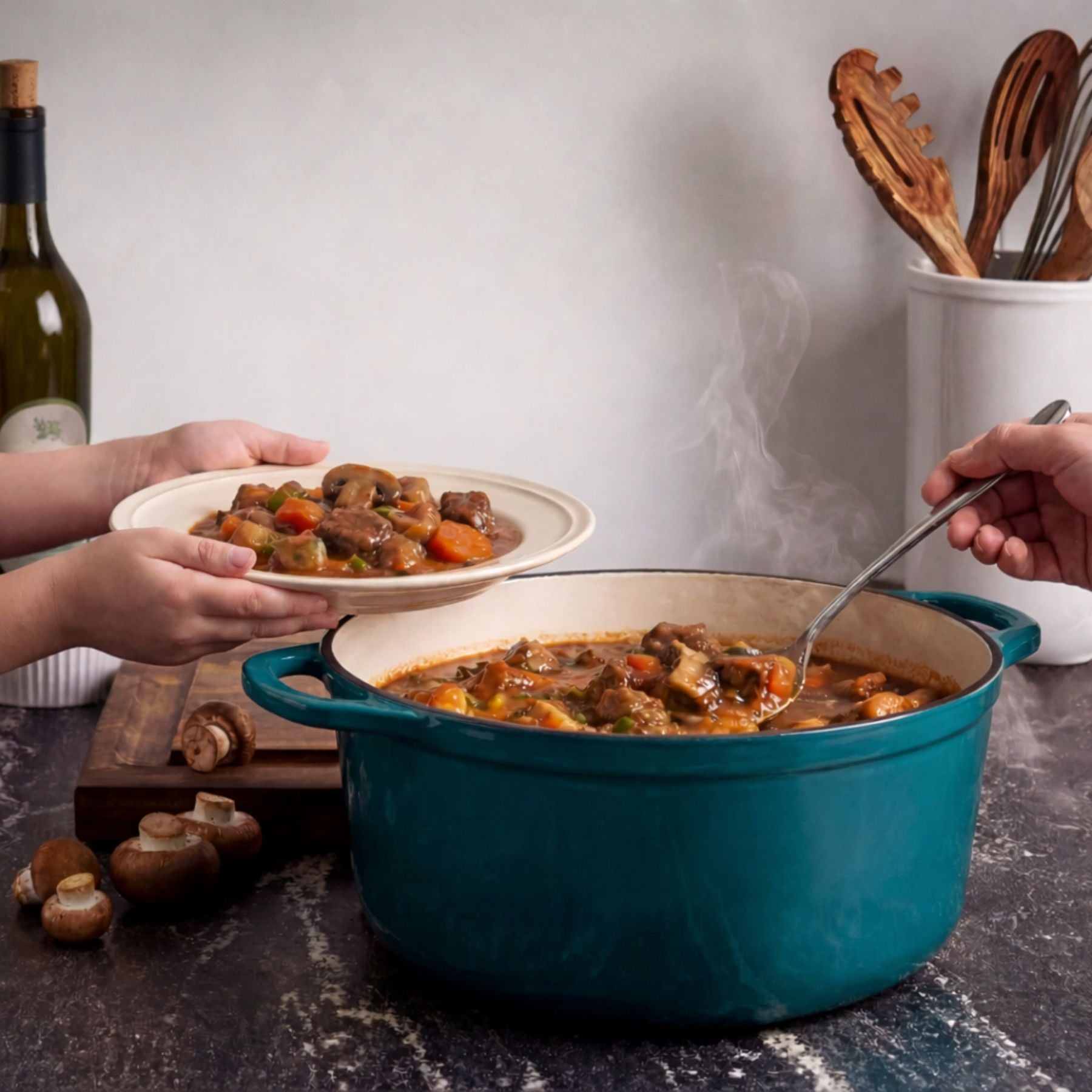 Steaming pot of stew with a person serving onto a plate, surrounded by cooking utensils and a bottle of wine.