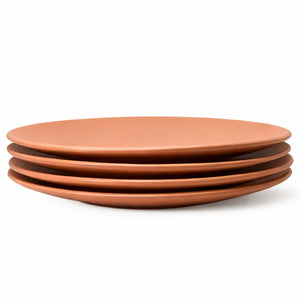 Stack of terracotta-colored ceramic plates on a white background