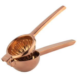 Copper-colored manual juicer on a white background