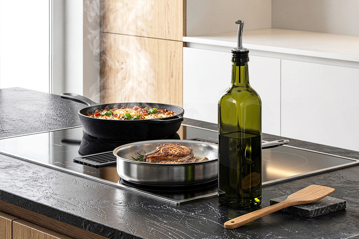 Kitchen scene with a stove, frying pan, bottle of olive oil, and wooden spatula.
