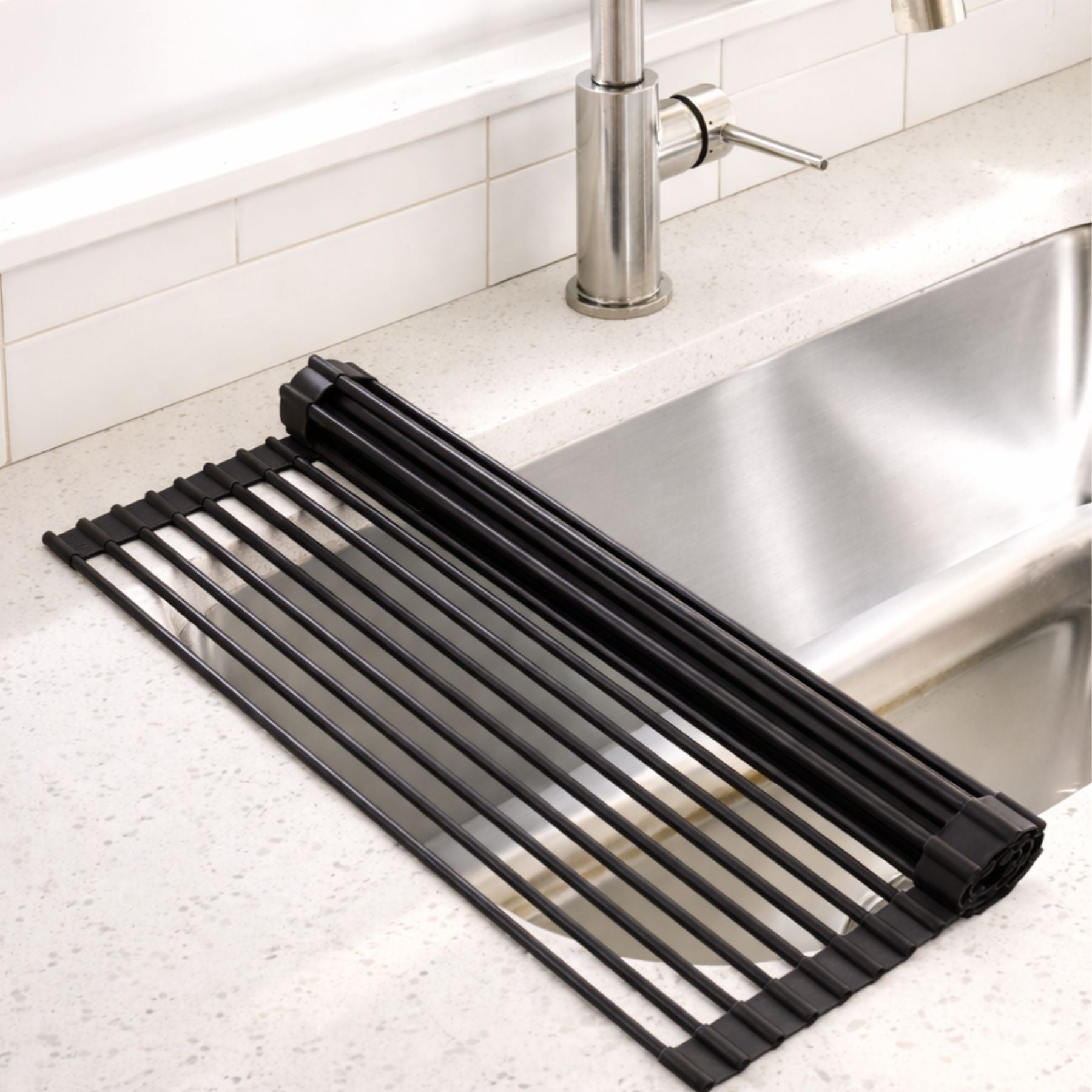 Black rolling rack on a kitchen counter next to a sink