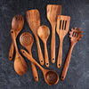Set of wooden kitchen utensils on a dark surface
