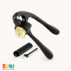 Black garlic press with minced garlic, cleaning brush, and peeler on a white background, featuring the ZUKI brand.