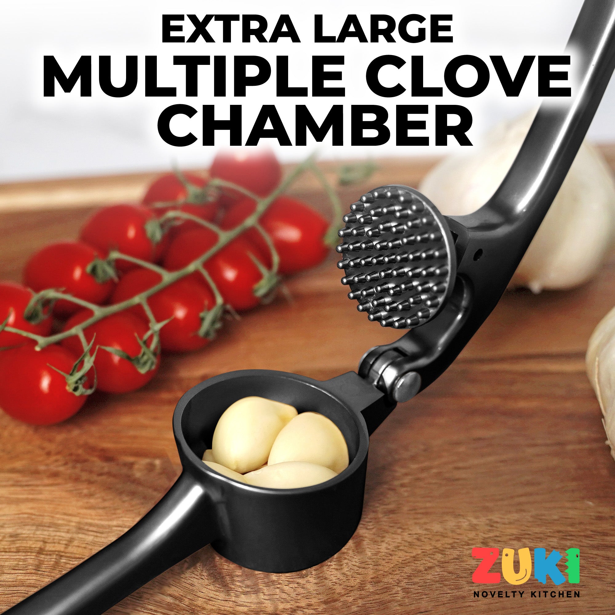 Garlic press with multiple clove chamber on a wooden surface with tomatoes and garlic in the background, featuring the ZUKI brand.