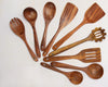 teak wood utensil set on a kitchen counter