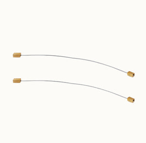 Two curved metal rods with gold ends on a white background