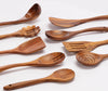 teak wood utensil set on a kitchen counter