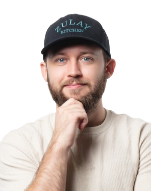 Jeremy wearing a black cap with 'Zulay Kitchen' logo on a white background